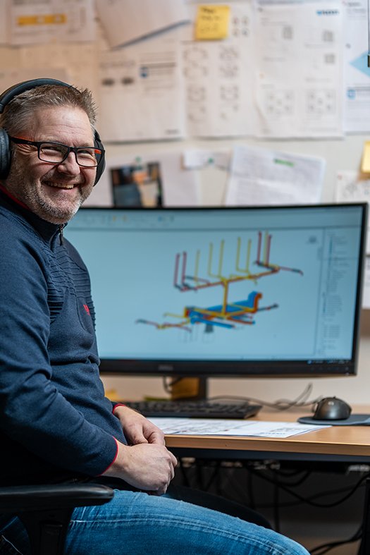 Employee working with technical project drawing at desk