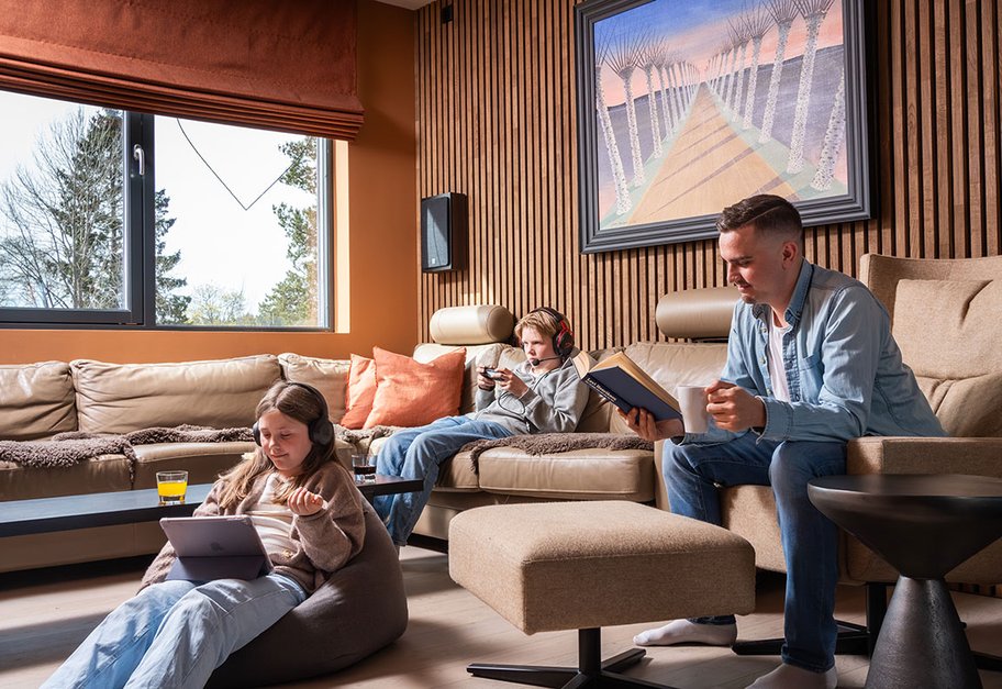 Family relaxing in a living room with natural light and healthy indoor air.