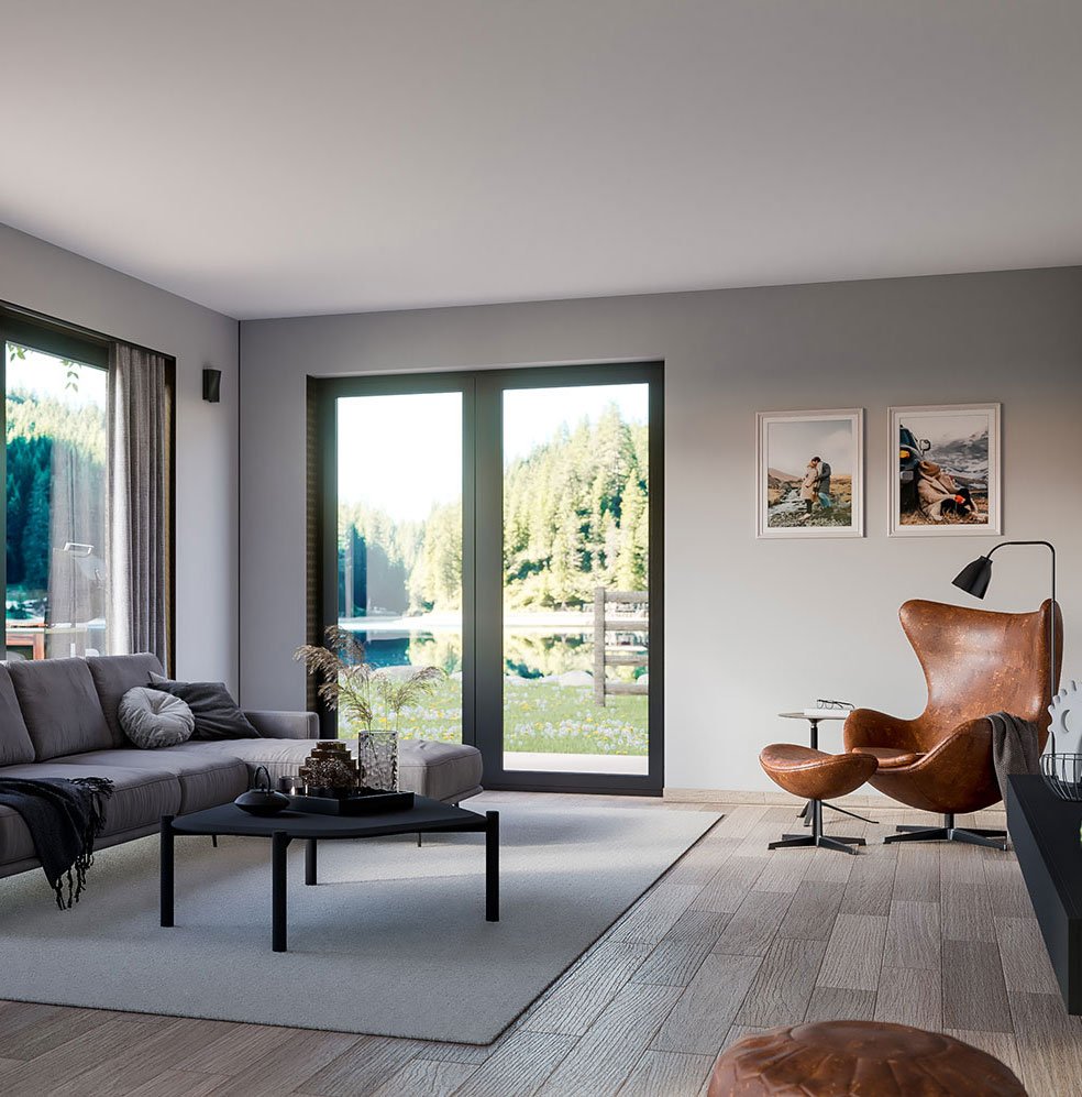 Diskré friskluftsventil montert i vegg mellom vinduer i moderne stue.