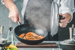 Steam rising from cooking in kitchen pan