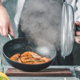 Steam rising from cooking in kitchen pan